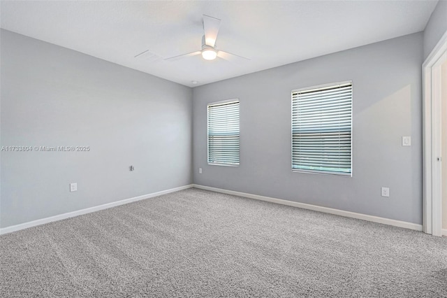 empty room with ceiling fan and carpet floors