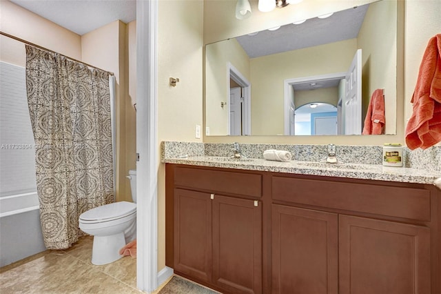 full bathroom featuring tile patterned flooring, vanity, shower / bath combo with shower curtain, and toilet