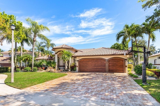 mediterranean / spanish-style home with a garage and a front yard