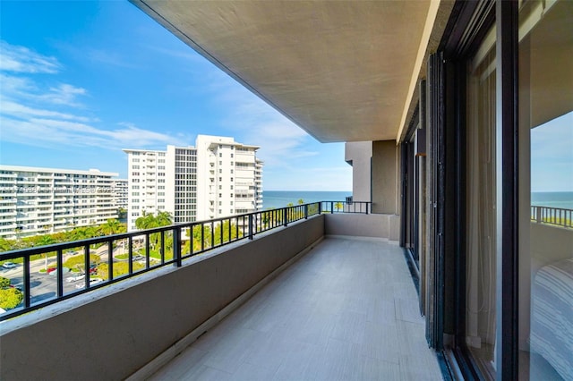 balcony with a view of city and a water view