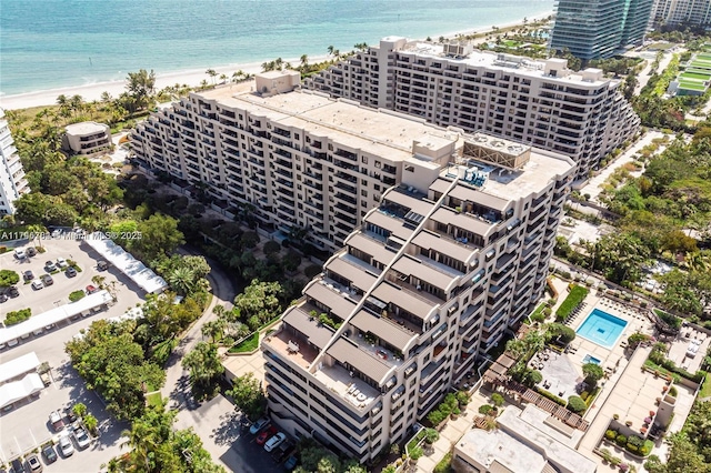 birds eye view of property featuring a water view, a view of city, and a view of the beach