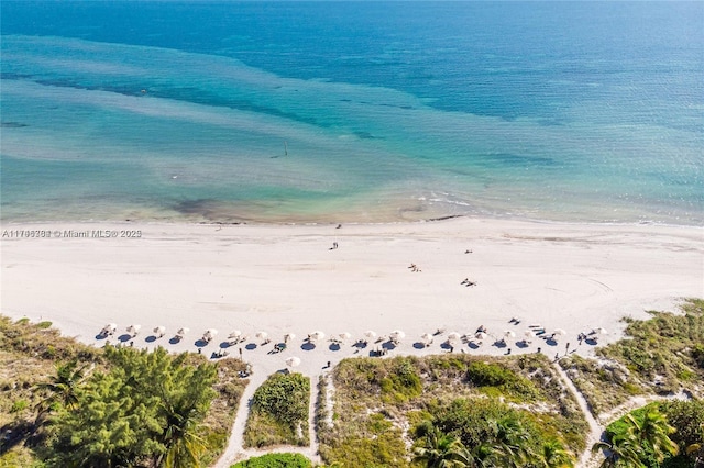 aerial view featuring a view of the beach and a water view