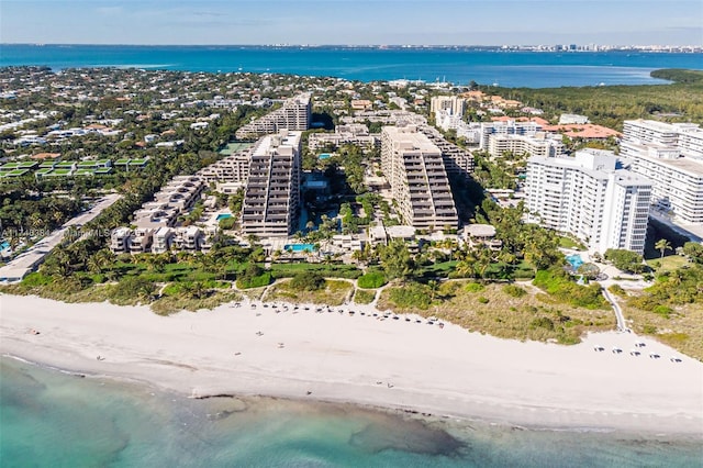 aerial view featuring a view of the beach, a water view, and a city view