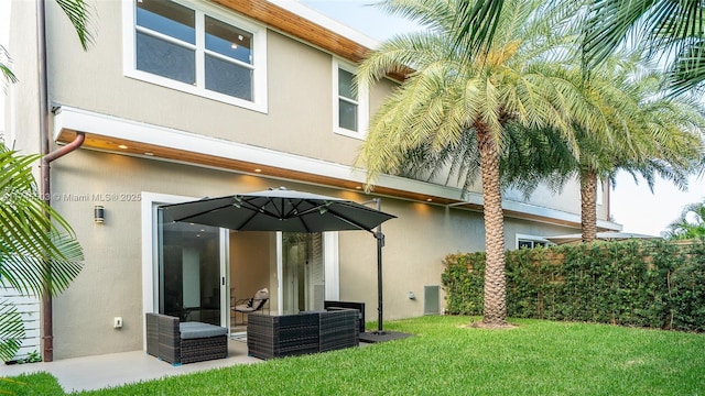 rear view of house with a patio area and a lawn