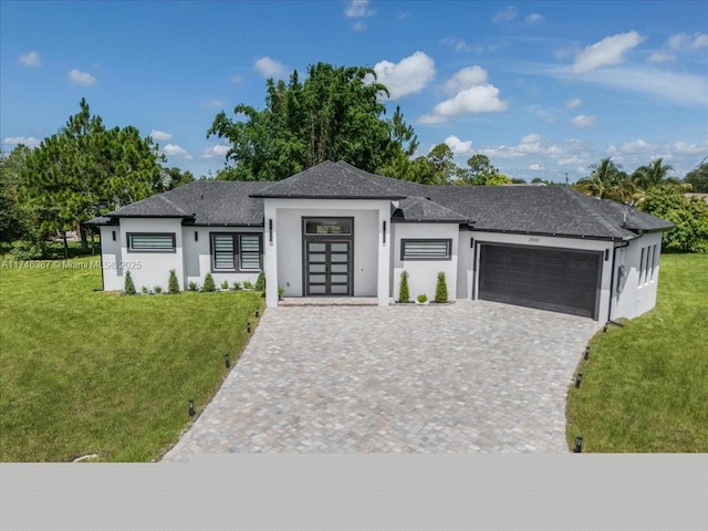 view of front of home with a garage and a front yard