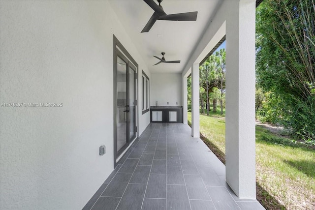 view of patio / terrace featuring ceiling fan and exterior kitchen