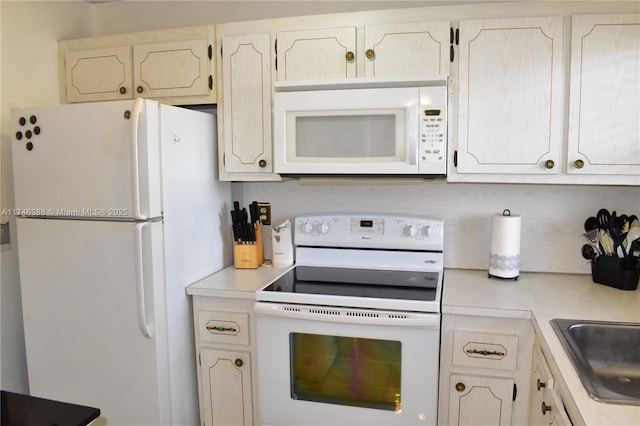 kitchen featuring sink and white appliances