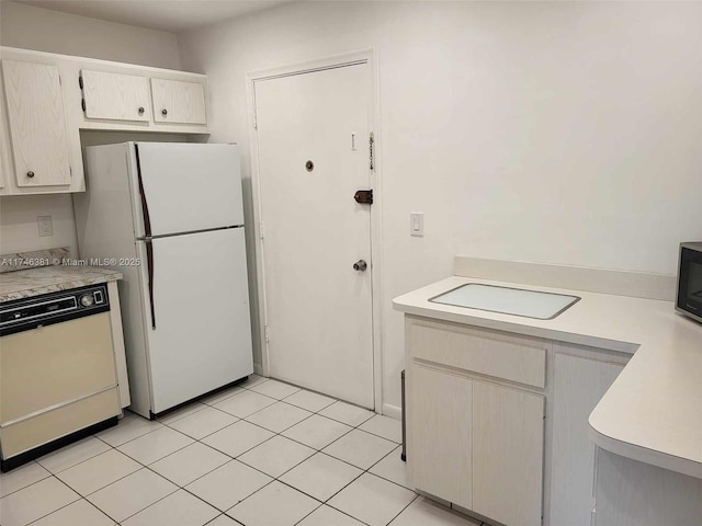 kitchen with light tile patterned flooring and white appliances