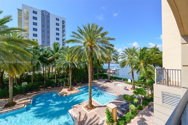 view of pool featuring a patio area and a water view