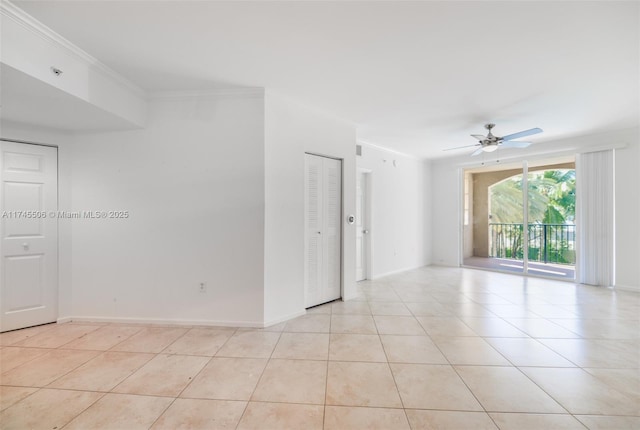 spare room with crown molding, ceiling fan, and light tile patterned floors