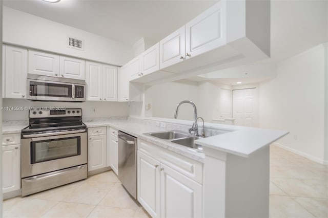 17100 N Bay Rd Unit 1303, Sunny Isles Beach, FL 33160 - kitchen featuring stainless steel appliances, a sink, a peninsula, light tile patterned flooring, and light countertops