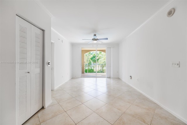 empty room featuring crown molding, ceiling fan, and light tile patterned flooring