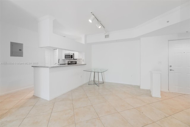 kitchen with light tile patterned flooring, rail lighting, white cabinets, electric panel, and kitchen peninsula