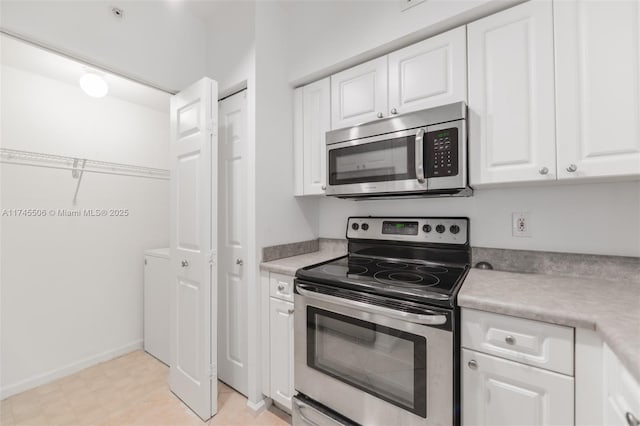 kitchen featuring white cabinets and appliances with stainless steel finishes