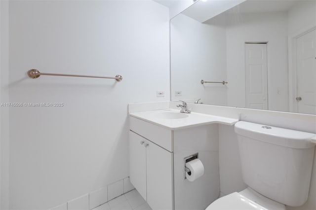 bathroom with vanity, tile patterned floors, and toilet