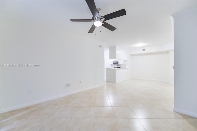 17100 N Bay Rd Unit 1303, Sunny Isles Beach, FL 33160 - spare room featuring ceiling fan, light tile patterned floors, and baseboards