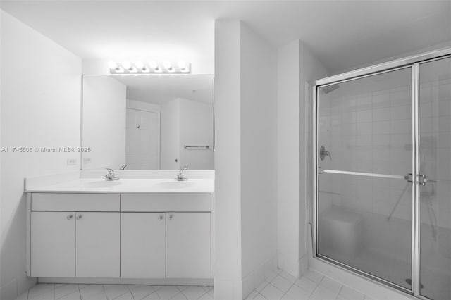 bathroom featuring vanity and an enclosed shower