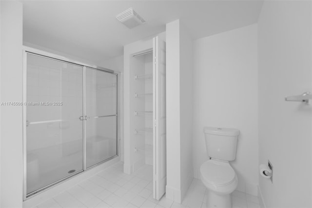 bathroom with walk in shower and toilet