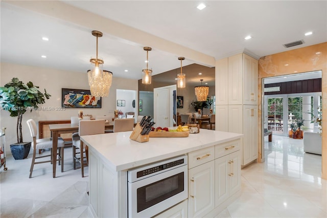 kitchen featuring a kitchen island, visible vents, pendant lighting, and recessed lighting