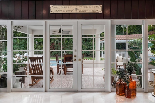 doorway to outside featuring a ceiling fan and french doors