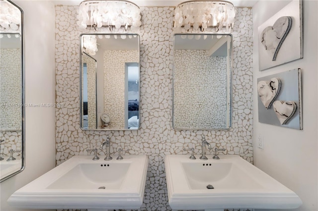 bathroom with an inviting chandelier and two sinks