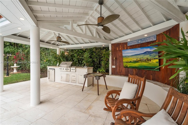 view of patio / terrace featuring ceiling fan, a gazebo, exterior kitchen, and grilling area