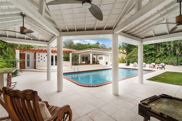 outdoor pool featuring a patio, a hot tub, and ceiling fan