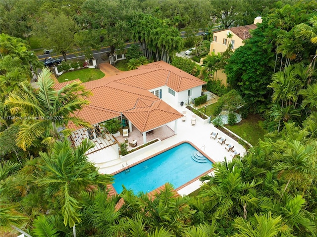 outdoor pool with a patio and a fenced backyard