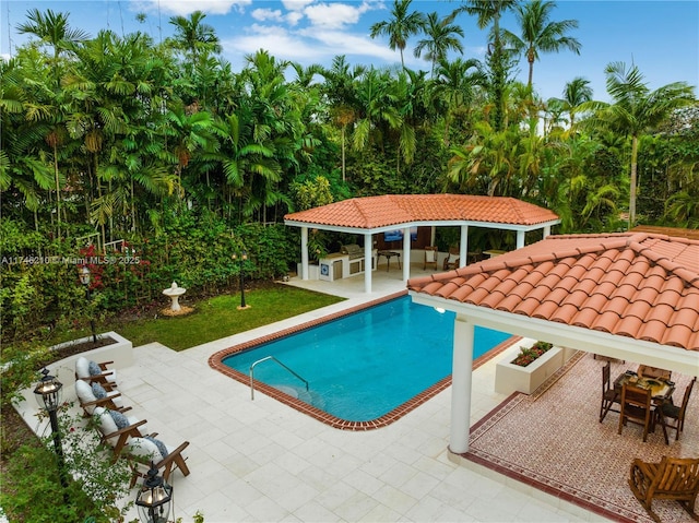 pool with a gazebo and a patio area