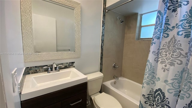 full bathroom featuring toilet, shower / bath combination with curtain, and vanity