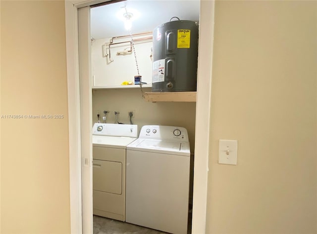 washroom with laundry area, washer and dryer, and electric water heater