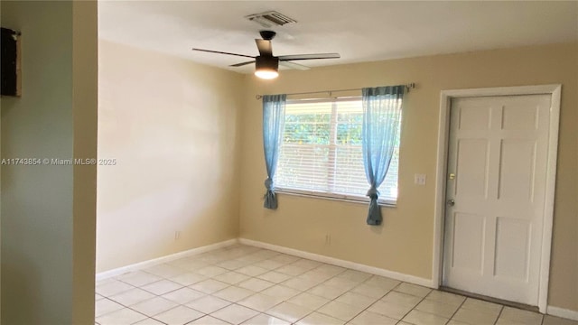 unfurnished room featuring light tile patterned floors, a ceiling fan, visible vents, and baseboards