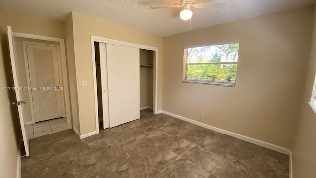 unfurnished bedroom with a closet, ceiling fan, a textured ceiling, and baseboards