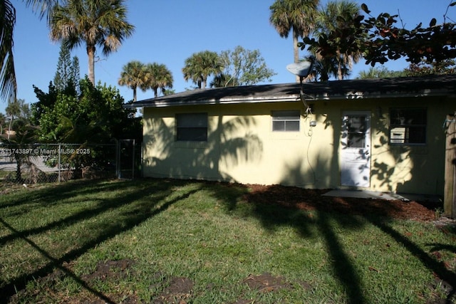 view of side of home featuring a lawn