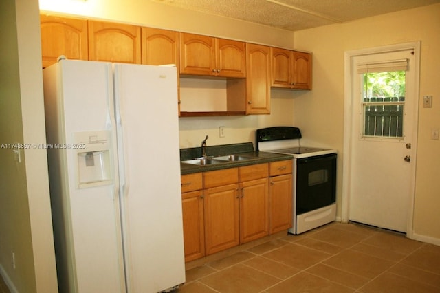 kitchen with sink, white fridge with ice dispenser, a textured ceiling, range with electric stovetop, and dark tile patterned floors