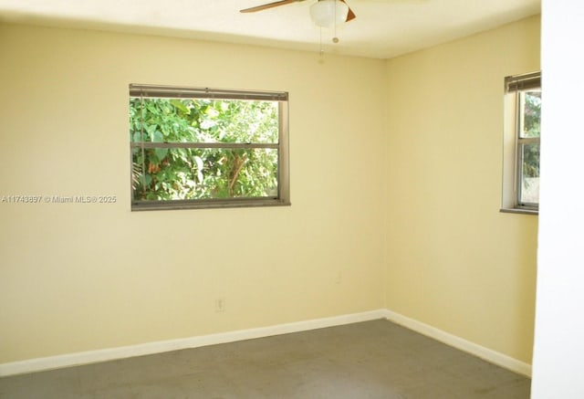 unfurnished room featuring ceiling fan and a healthy amount of sunlight