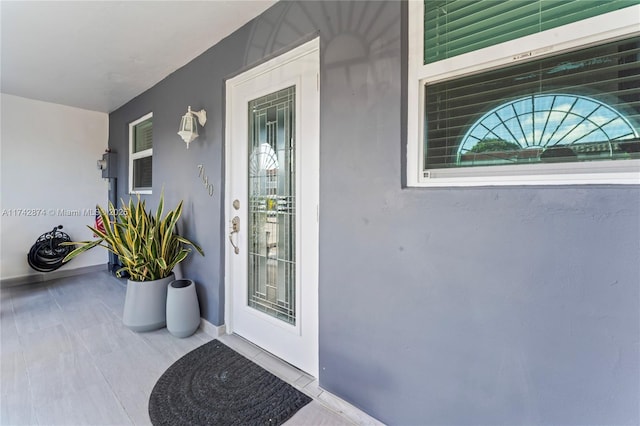 entrance to property with stucco siding