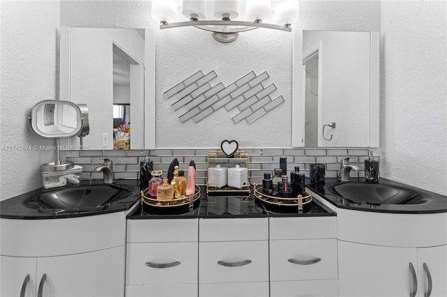 bathroom with double vanity, backsplash, and a sink