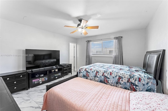 bedroom featuring marble finish floor and a ceiling fan