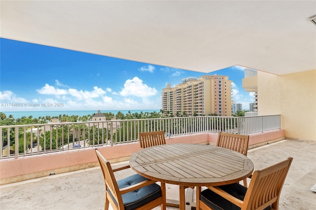 view of patio with a balcony and a water view