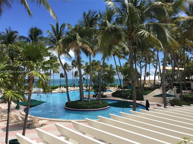 view of pool featuring a water view