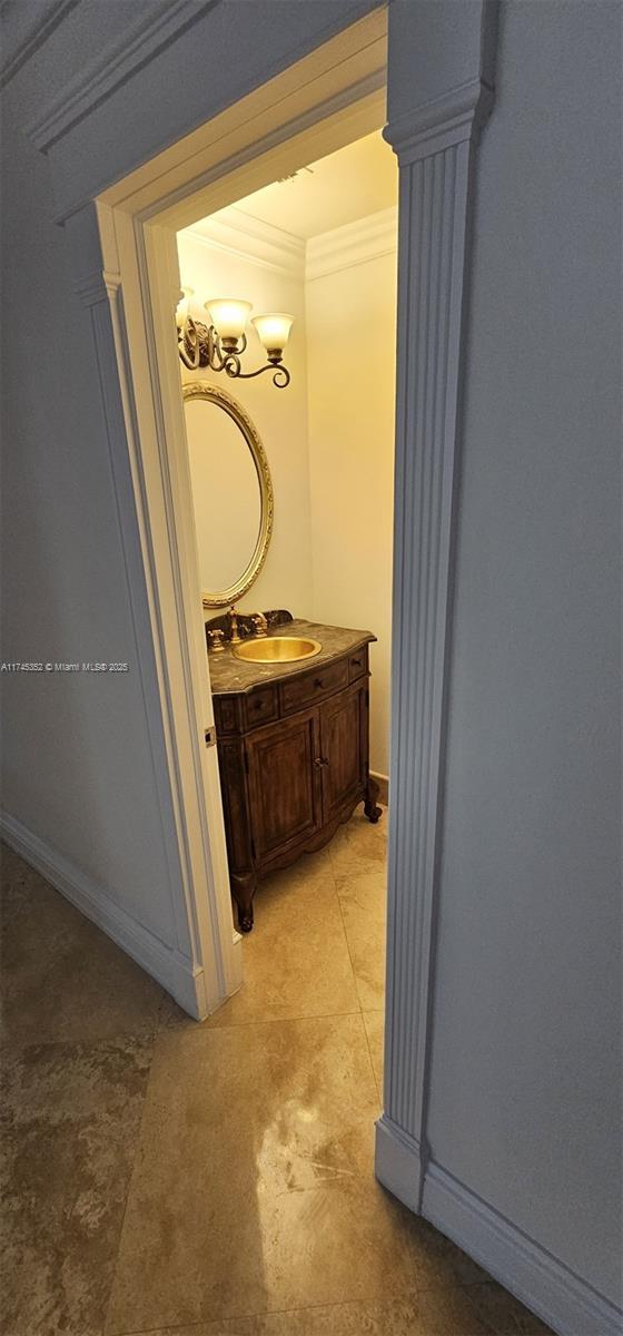 hallway featuring ornamental molding and sink