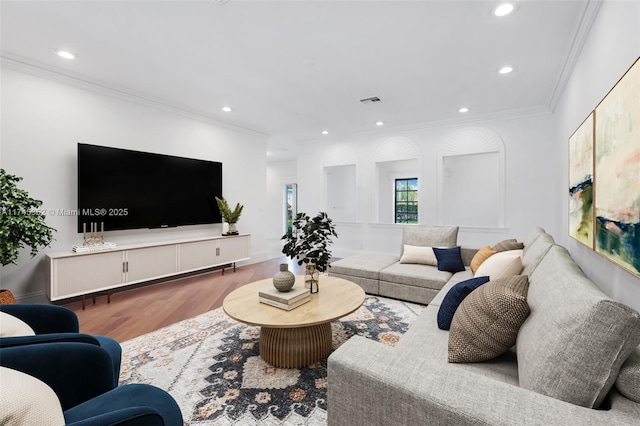 living room featuring wood-type flooring and crown molding