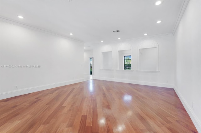 unfurnished room featuring crown molding and light hardwood / wood-style flooring