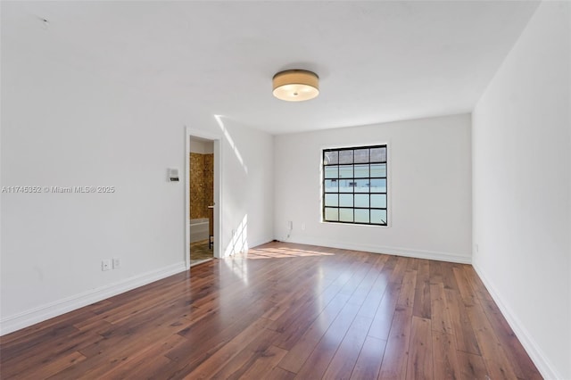 empty room featuring dark hardwood / wood-style flooring