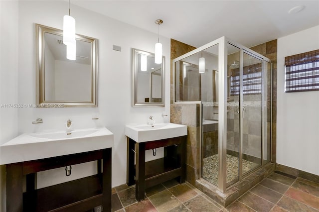 bathroom featuring vanity and a shower with shower door