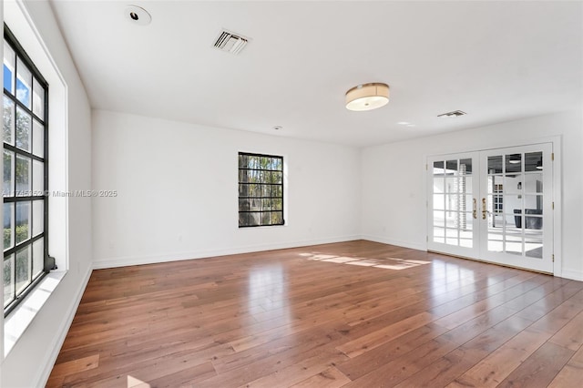 spare room with light wood-type flooring and french doors