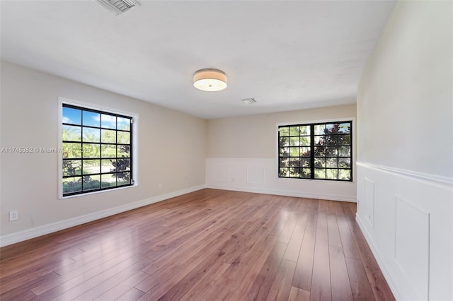 empty room with light hardwood / wood-style flooring