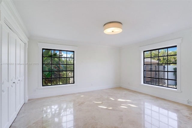 spare room featuring crown molding