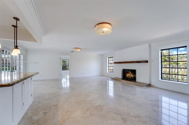 unfurnished living room featuring crown molding